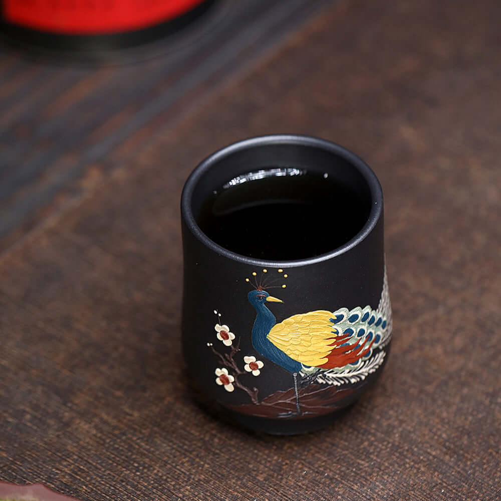 Handmade Yixing purple sand cup with peacock design, perfect for kung fu tea set, showcasing original craftsmanship.