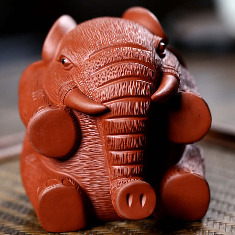 Handmade Yixing purple sand elephant sculpture, unique tea pet decoration for creative tea tables.