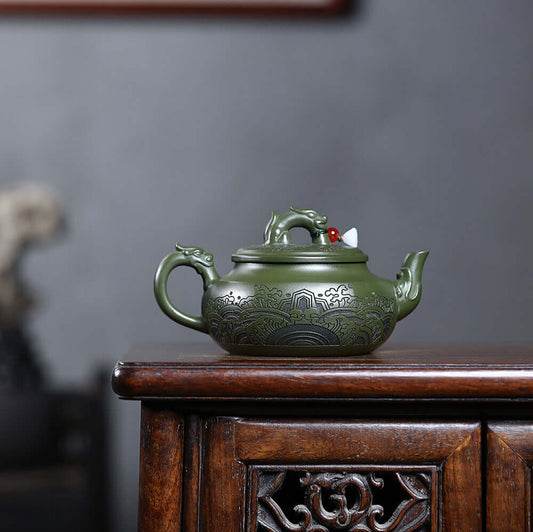 Handmade Yixing purple sand teapot in black green mud with intricate dragon design, perfect for home kung fu tea set.