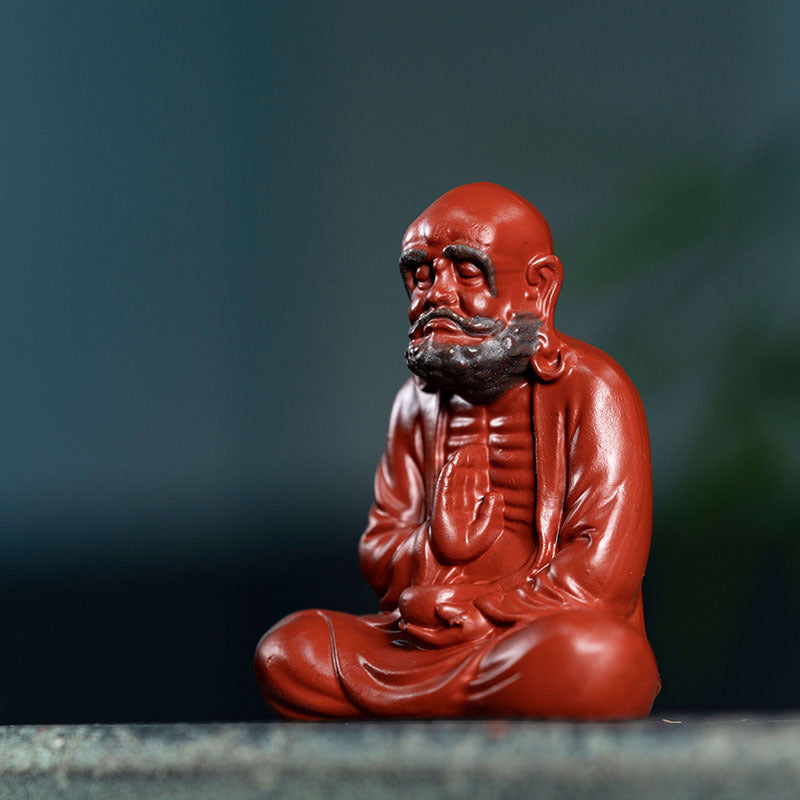 Handmade Yixing purple sand tea pet sculpture of a seated monk, perfect for tea accessories and decoration.