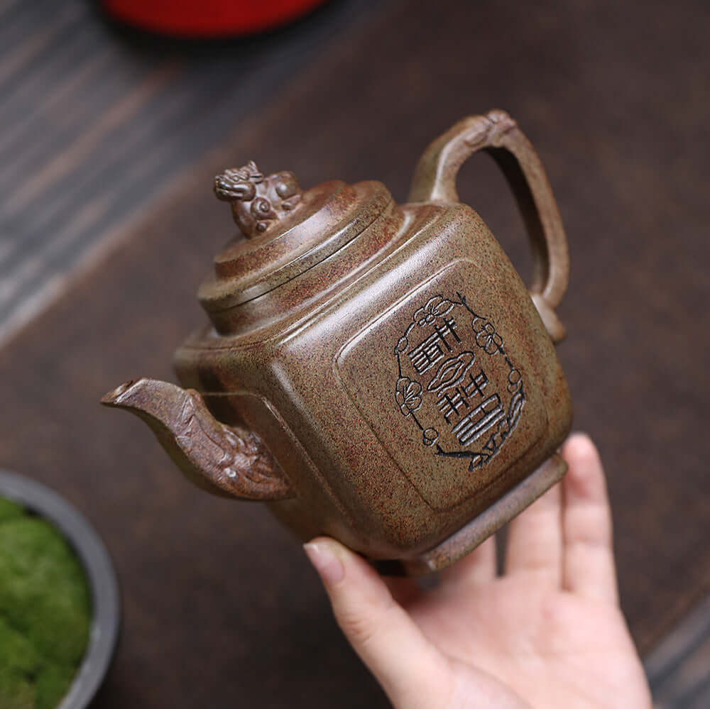 Handmade Yixing purple sand teapot with intricate design, showcasing traditional craftsmanship, perfect for kung fu tea sets.