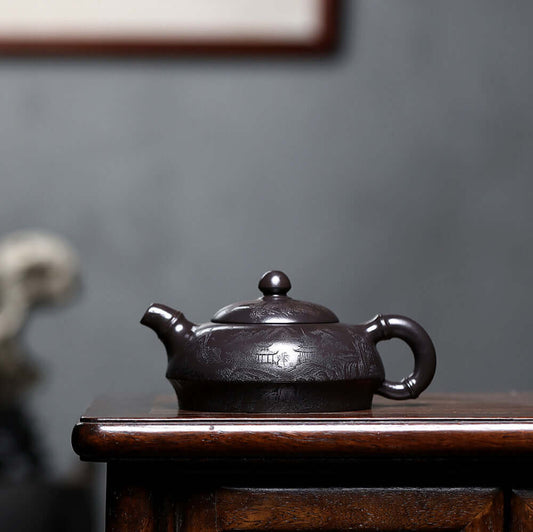 Handmade Yixing purple sand teapot with intricate designs, ideal for home kung fu tea sets.