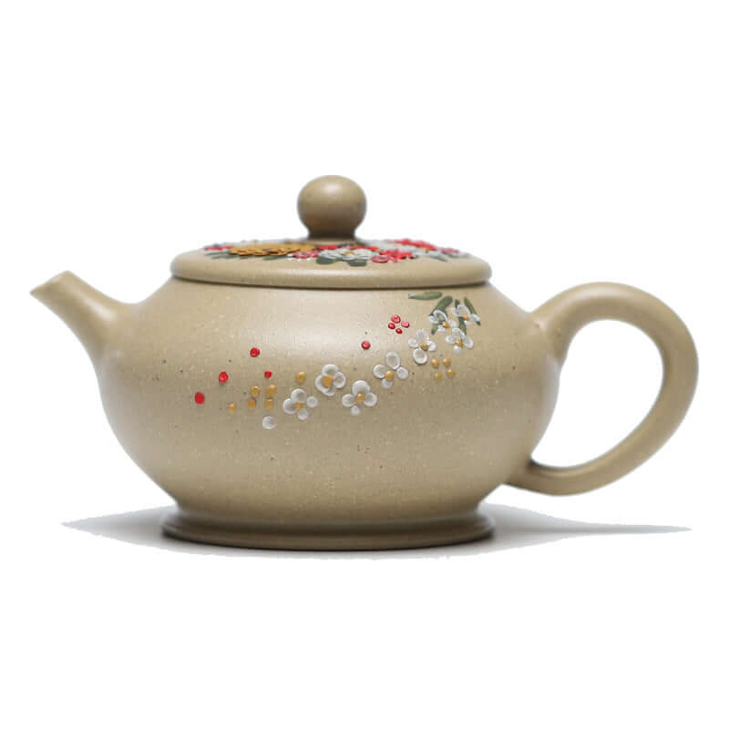 Handmade Yixing purple sand teapot with floral design, featuring a rounded body and elegant handle.