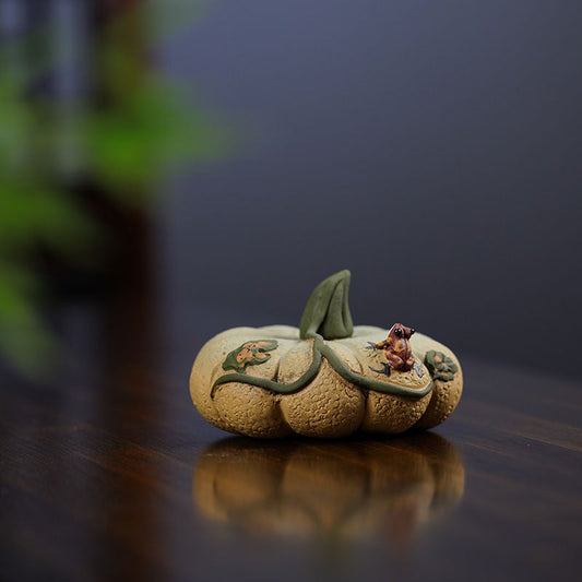 Handmade Yixing purple sand pumpkin tea pet ornament, featuring a frog design, perfect for tea sets and collectors.