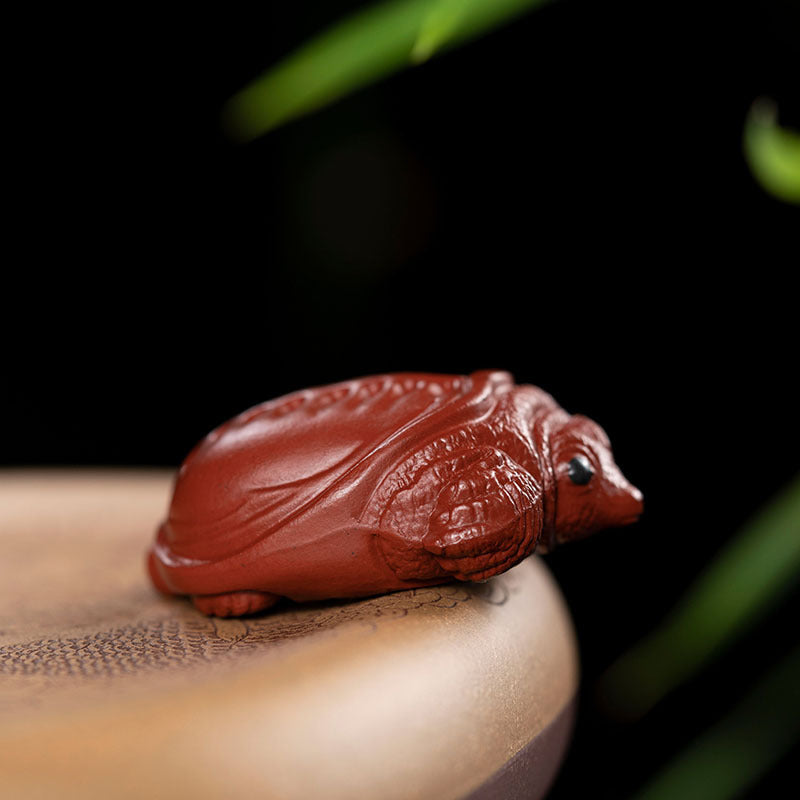 Handmade Yixing purple sand tea pet ornament, rich armor design, ideal for tea lovers and collectors.