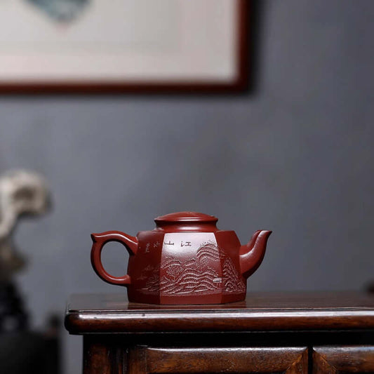 Handmade Yixing purple sand teapot with intricate mountain design, perfect for kung fu tea ceremonies.