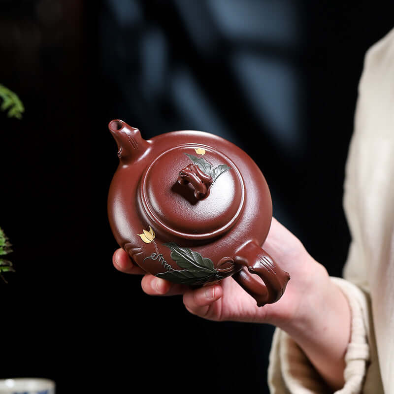 Handmade Yixing purple sand teapot with floral design, showcasing intricate craftsmanship and original purple ore.