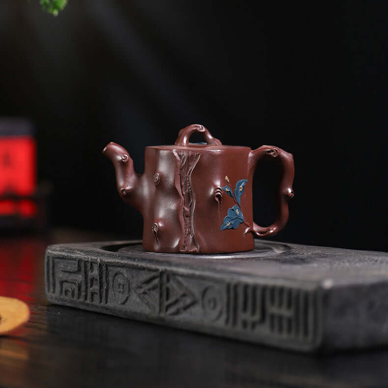 Handmade Yixing purple sand teapot with intricate design, crafted by skilled artisans, perfect for tea enthusiasts.