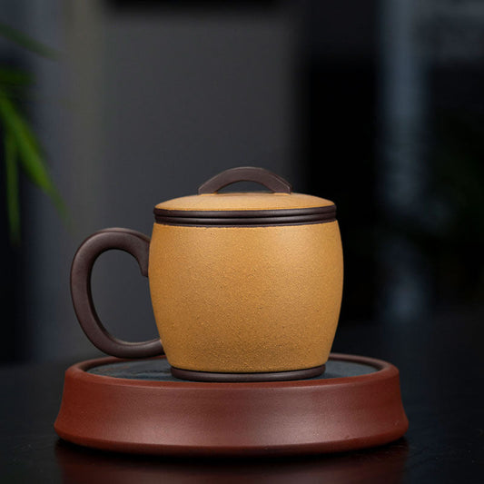 Handmade Yixing purple sand cup with lid on a brown saucer, showcasing original craftsmanship for tea lovers.