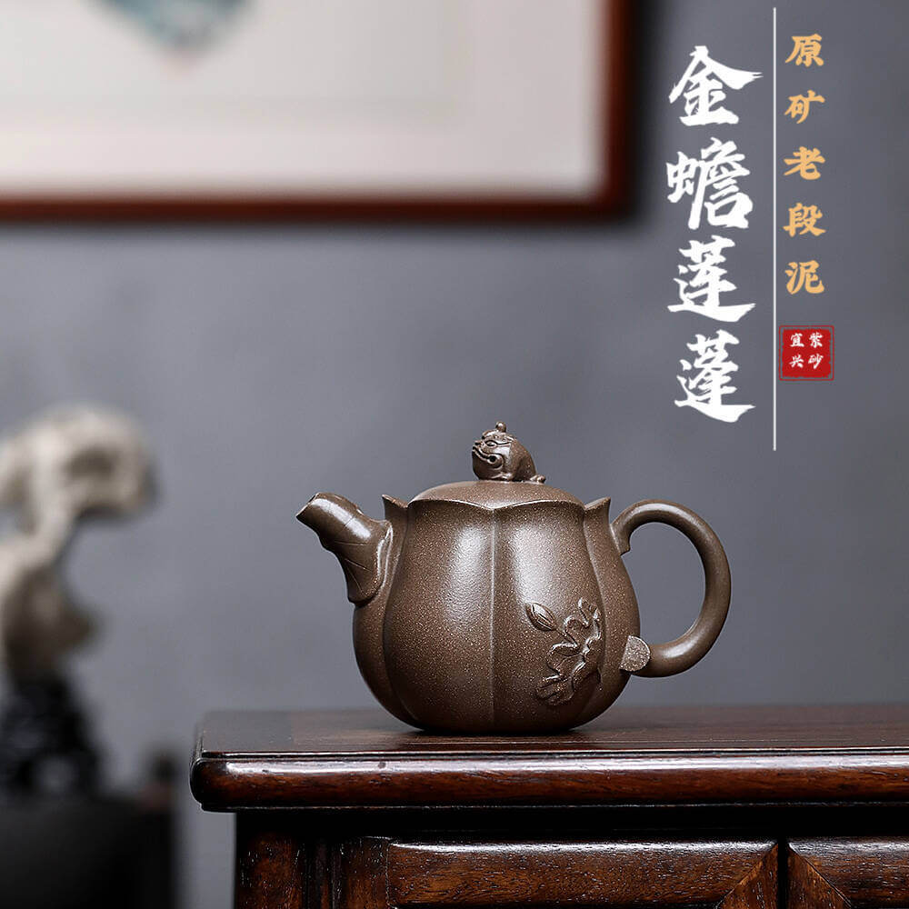 Handmade Yixing purple sand teapot featuring a lotus and golden toad design, perfect for home kung fu tea sets.