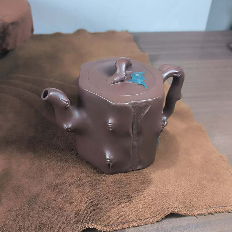 Handmade Yixing purple sand teapot with high tree stump design, showcasing original craftsmanship and unique styling.