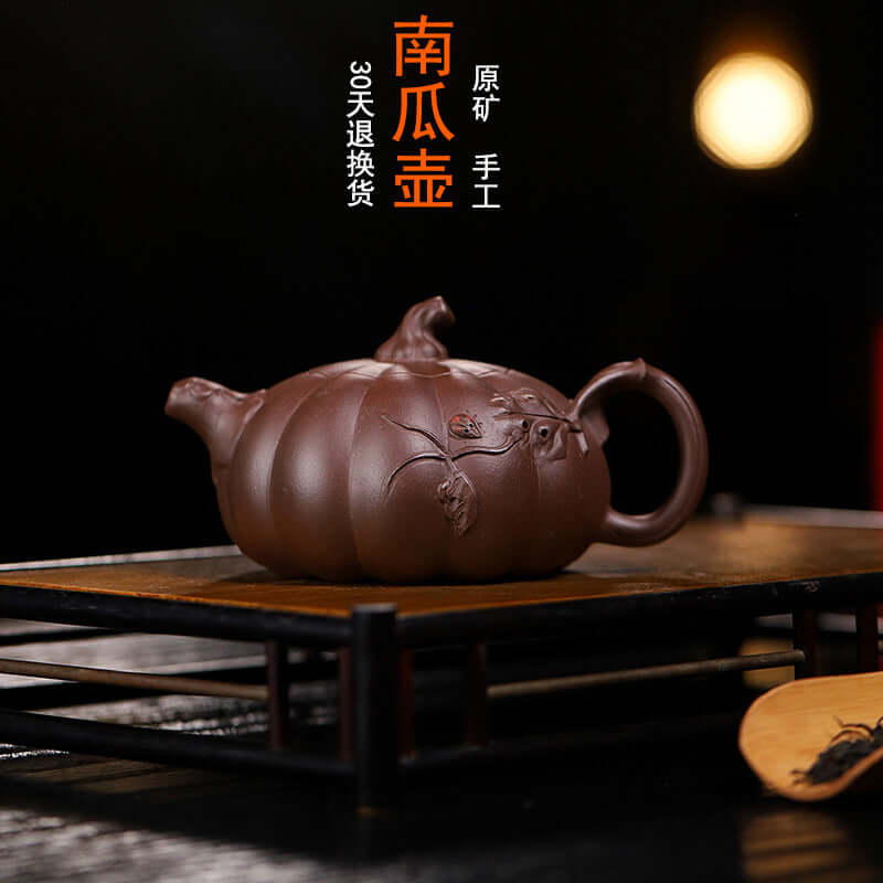Handmade Yixing purple sand teapot in pumpkin shape, crafted by skilled artisans, perfect for home tea brewing.