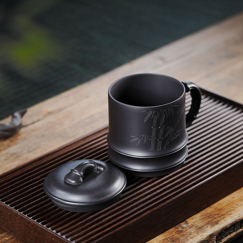 Handmade Yixing purple sand lidded cup with bamboo design, large capacity double-walled filter for tea brewing.