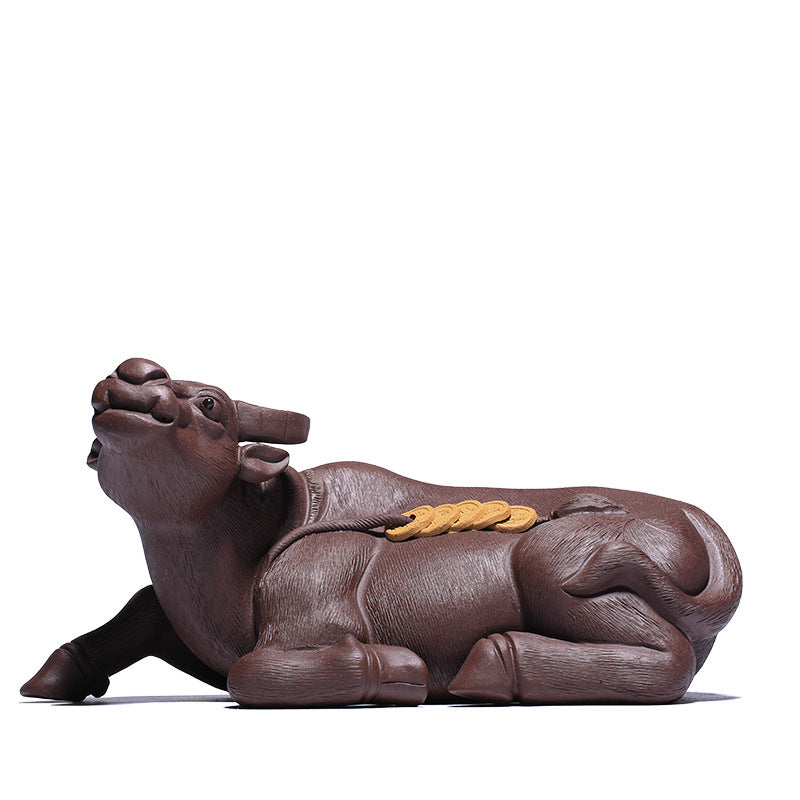 Handmade Yixing purple sand tea pet in the shape of a cow, symbolizing wealth and prosperity, tea ceremony decoration.