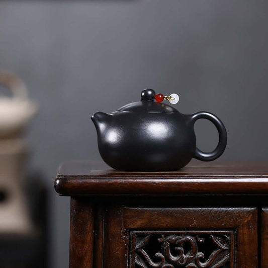Handmade Yixing purple sand teapot with inverted handle, original black iron stone, perfect for Kung Fu tea sets.