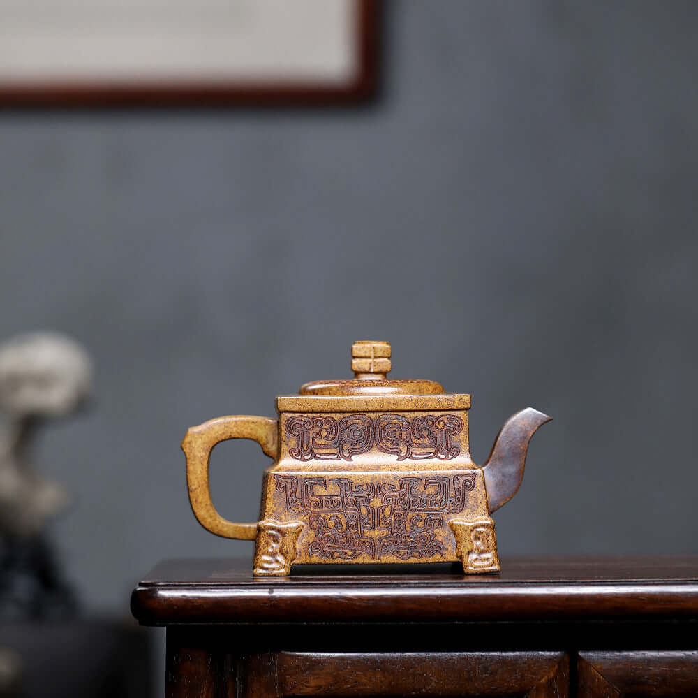 Handmade Yixing purple sand teapot in Sifang style, showcasing intricate designs, perfect for household kung fu tea sets.