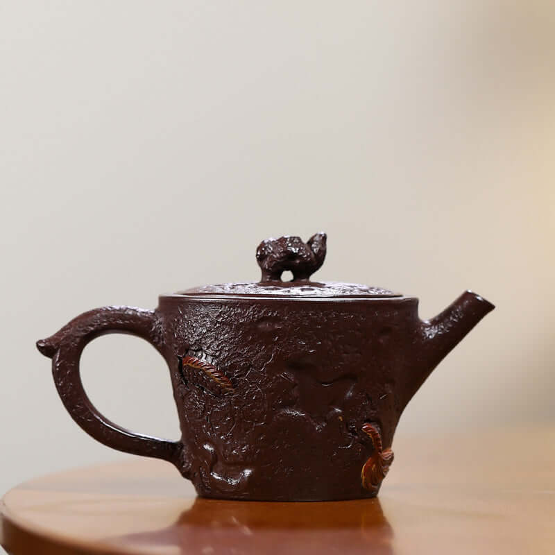 Handmade Yixing purple sand teapot with intricate design, showcasing traditional craftsmanship and unique artistry.