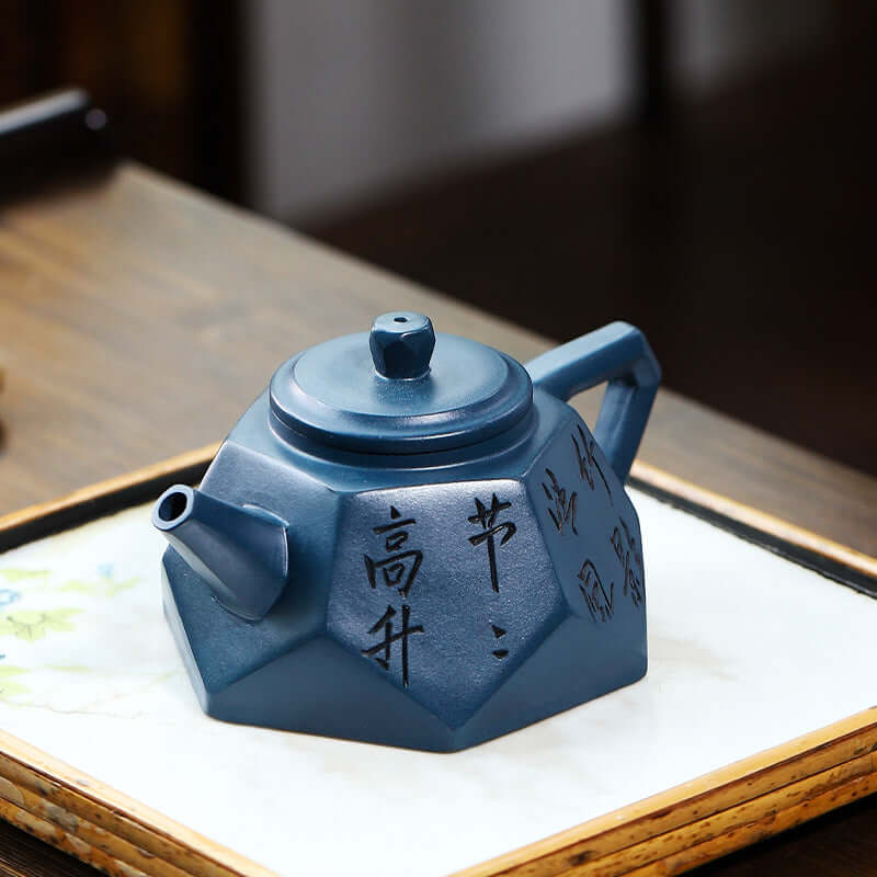 Handmade Yixing purple sand teapot with diamond shape and intricate engravings, perfect for tea brewing.
