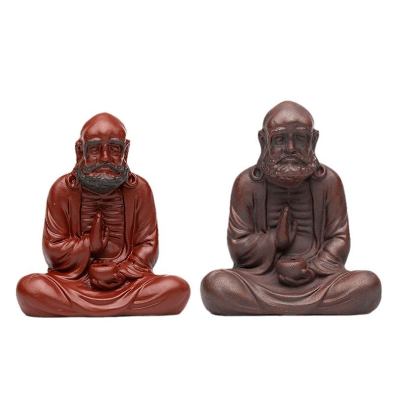 Handmade Yixing purple sand tea pet ornaments, featuring detailed character sculptures, ideal for tea lovers.