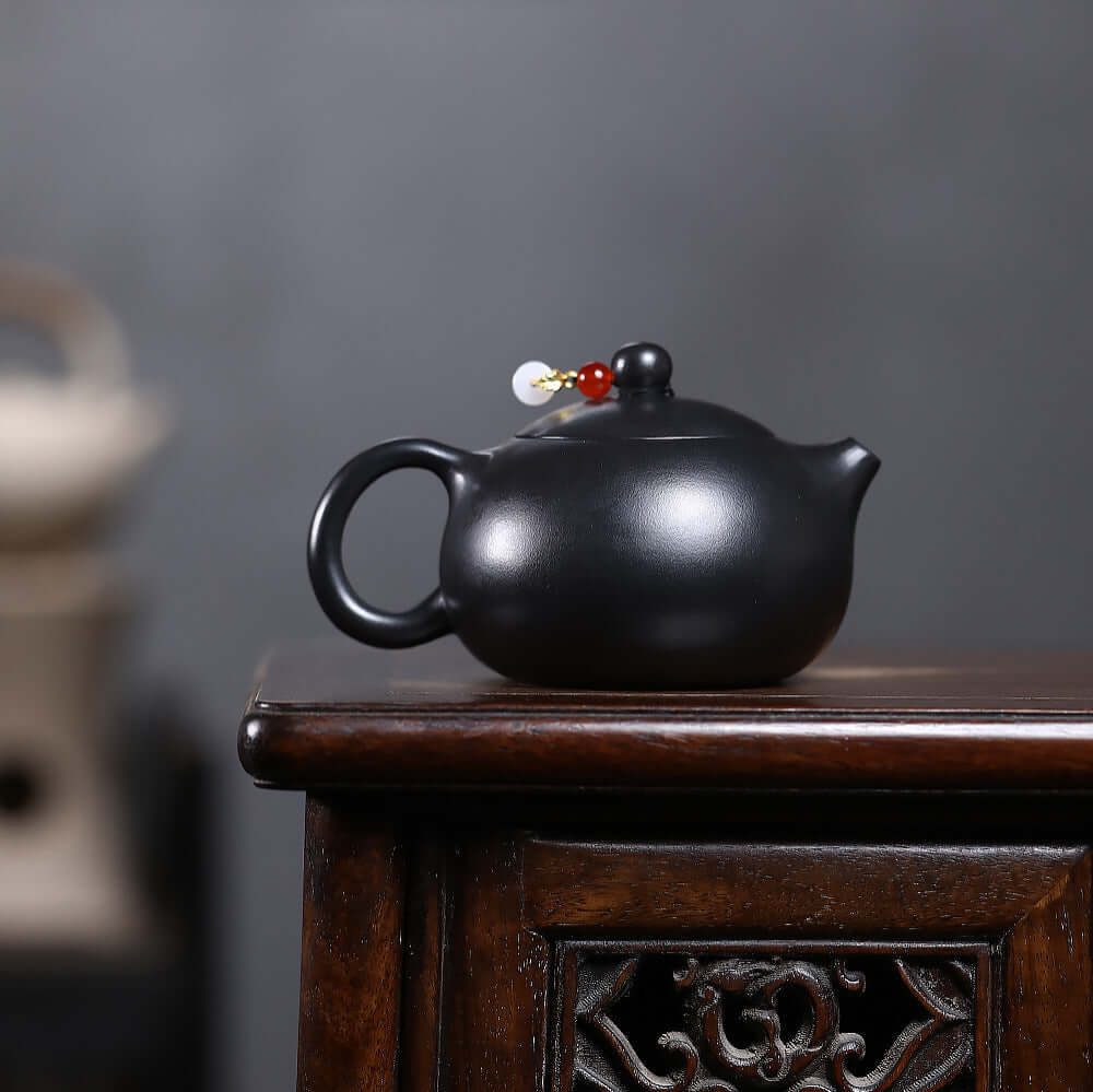 Handmade Yixing purple sand teapot with inverted handle, crafted from original mineral black iron stone, perfect for Kung Fu tea.
