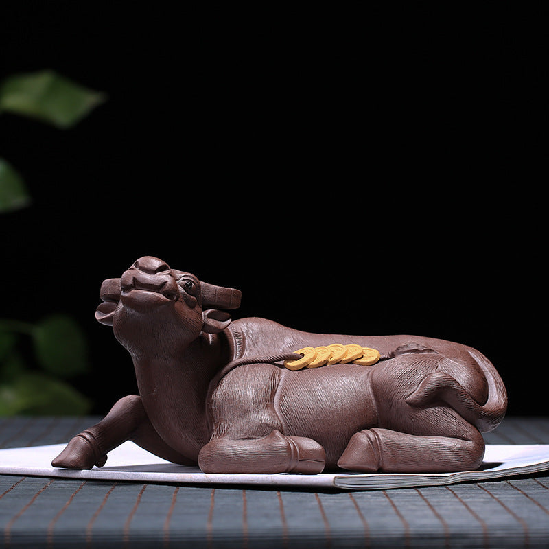Handmade Yixing purple sand tea pet in the shape of a cow, symbolizing wealth and blessings, perfect for tea ceremony decoration.