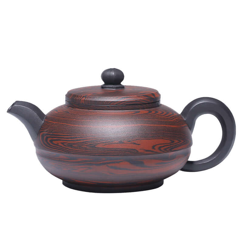 Handmade Yixing purple sand teapot with elegant swirling patterns, featuring a rounded body and traditional lid.