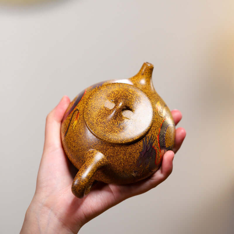 Handmade Yixing purple sand teapot with intricate dragon design, showcasing color-changing properties and elegant craftsmanship.