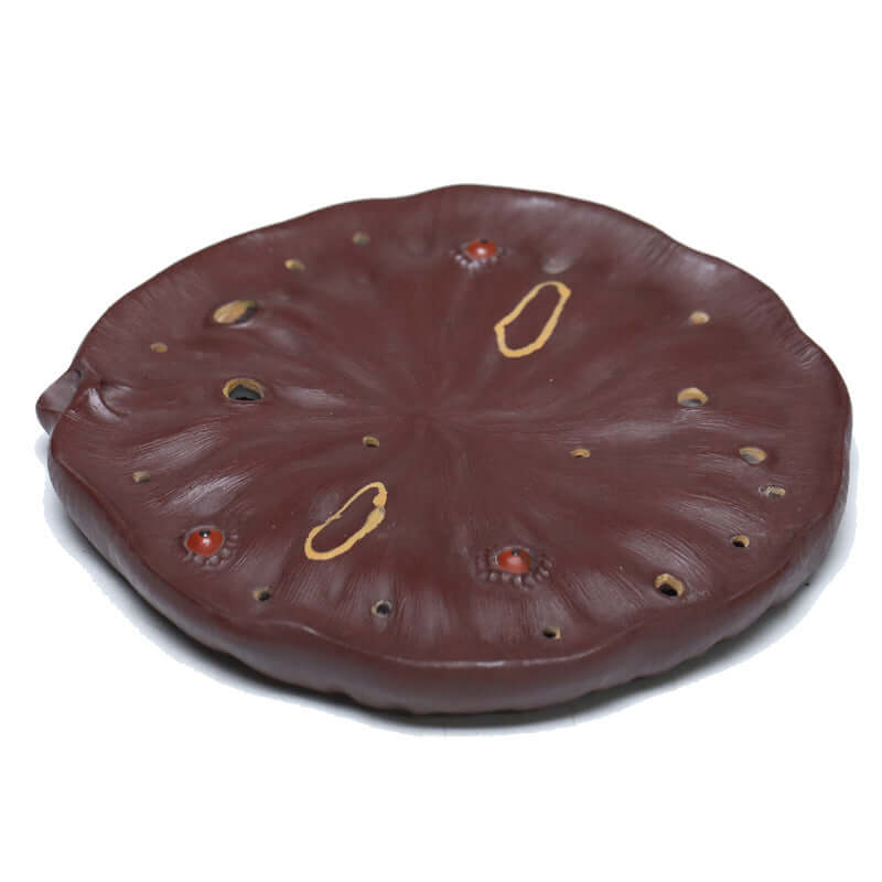 Handmade Yixing purple sand lotus pot pad, featuring intricate details and unique purple mud texture.
