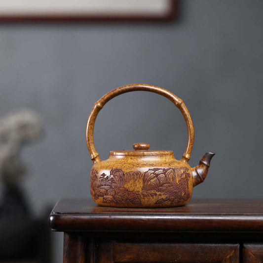 Handmade Yixing purple sand teapot with mountain scenery, crafted by Yixing artisan for authentic kung fu tea experience.