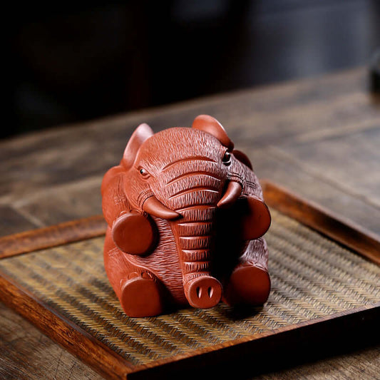 Handmade Yixing purple sand elephant sculpture, perfect for tea table decoration, symbolizing good fortune and artistry.