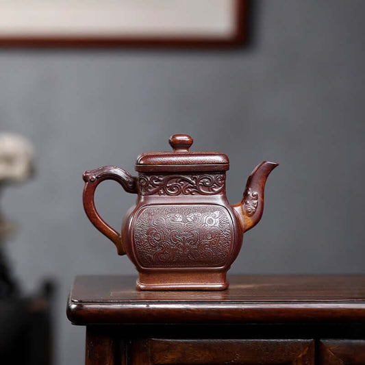 Handmade Yixing purple sand teapot with intricate design, perfect for tea enthusiasts and collectors.