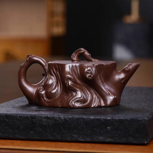 Handmade Yixing purple sand teapot with intricate design, crafted from original purple sand, showcasing artisan craftsmanship.