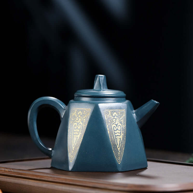 Handmade Yixing purple sand teapot in Tianqing mud, featuring intricate golden designs.