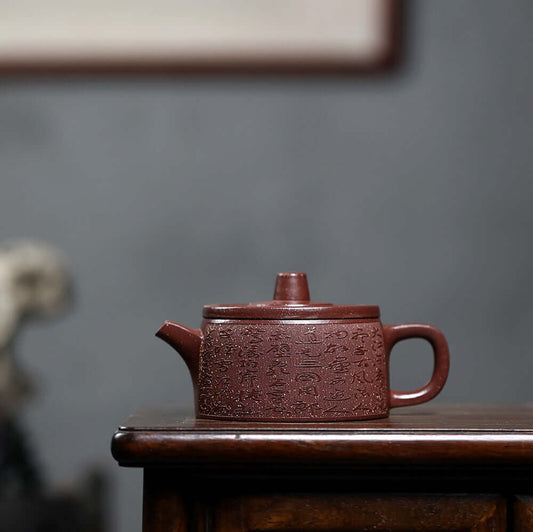 Handmade Yixing purple sand teapot with intricate designs, perfect for home kung fu tea sets.