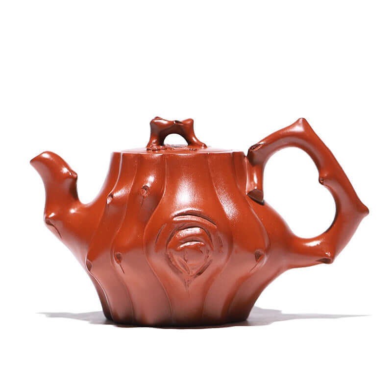 Handmade Yixing purple sand teapot with a unique bamboo design and rich red color, perfect for tea enthusiasts.