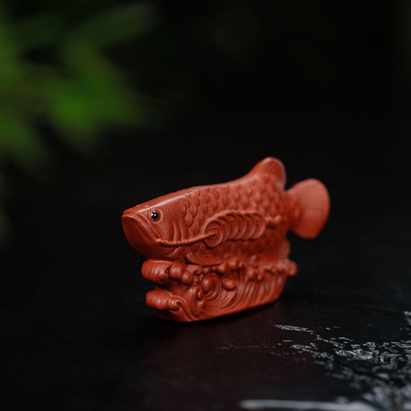 Handmade Yixing purple sand tea pet sculpture featuring a golden dragon fish, perfect for tea ceremonies.