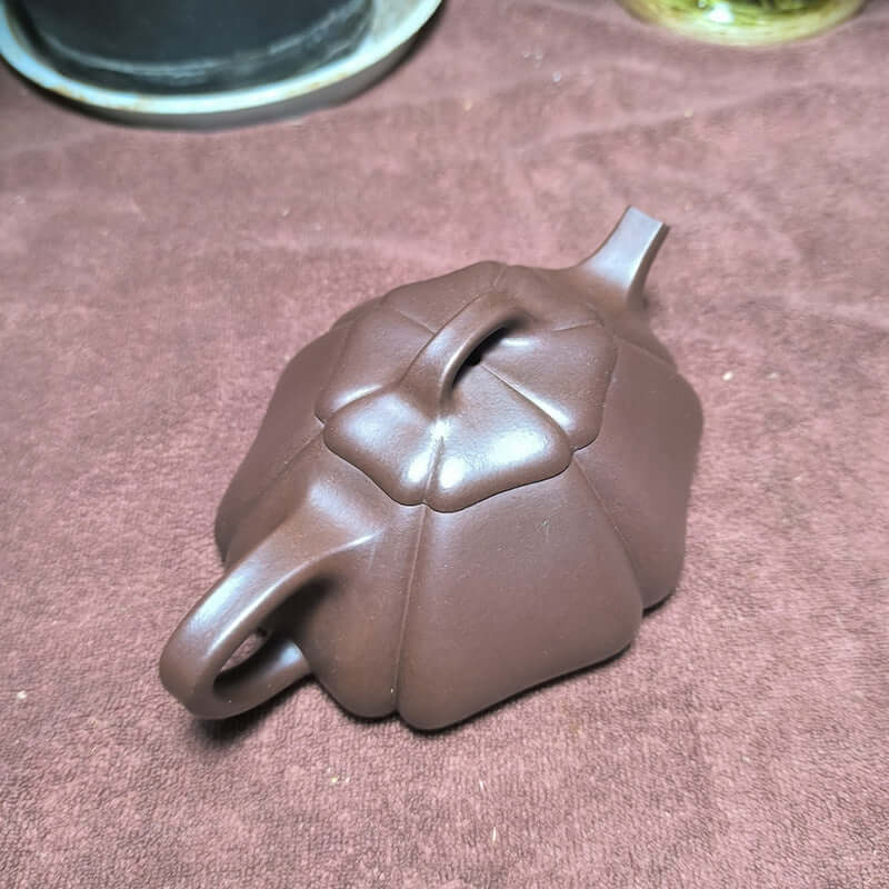 Handmade Yixing purple sand teapot featuring a unique gourd shape and rich original purple sand craftsmanship.