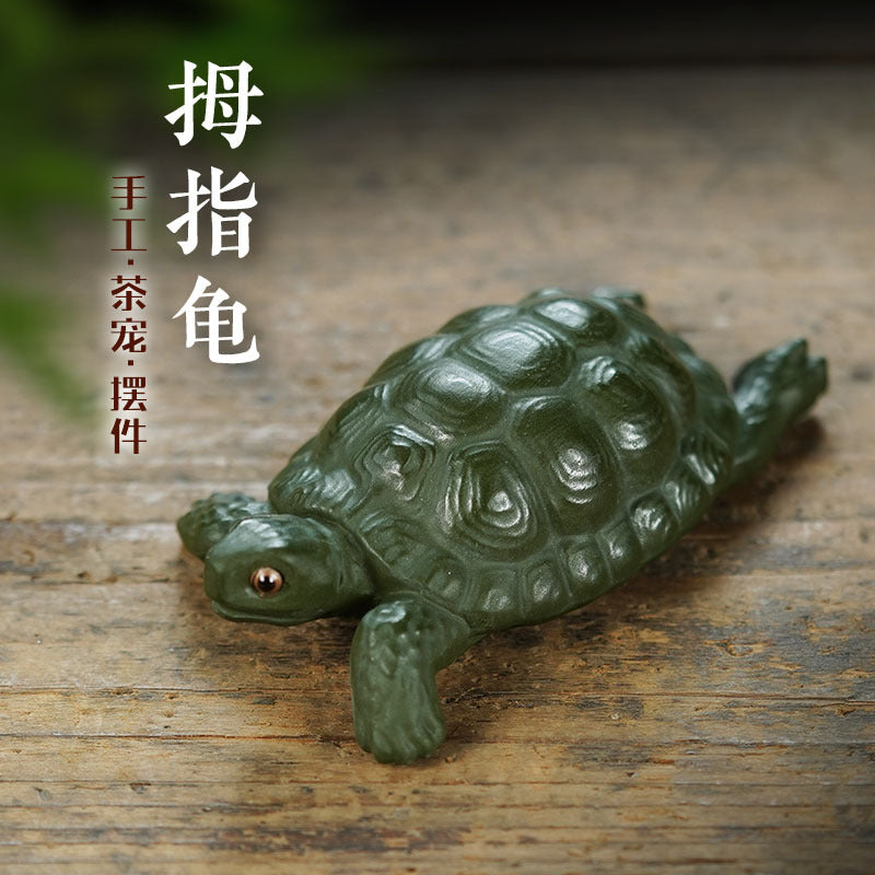 Handmade Yixing purple sand turtle sculpture, ideal for tea table decor and creative tea play. Unique green mud ornament.