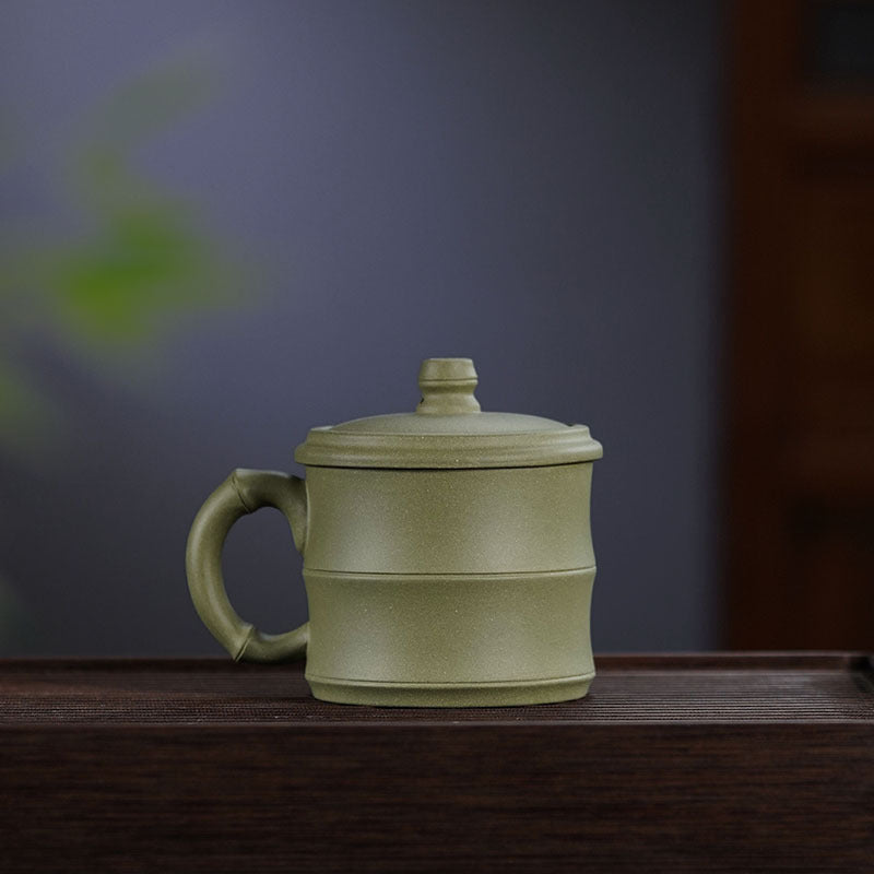 Handmade Yixing purple sand tea cup with bamboo section cover for water separation, perfect for office use.