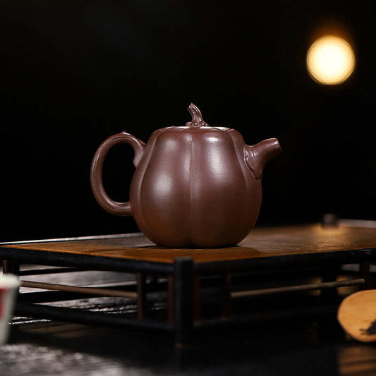 Handmade Yixing purple sand teapot in pumpkin shape, perfect for home tea brewing, crafted from original purple sand.