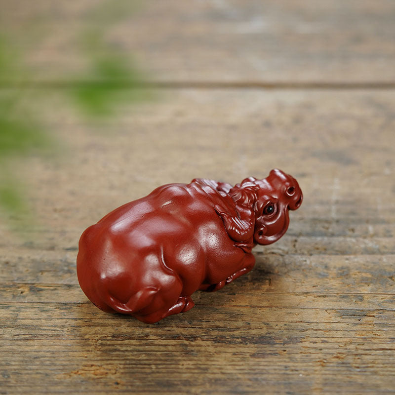 Handmade Yixing purple sand tea pet, zodiac cattle ornament for tea play, crafted by Yixing artisans.