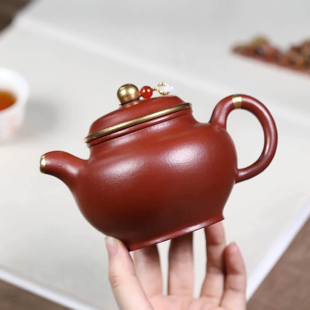 Handmade Yixing purple sand teapot with gold inlay, original mineral surface, ideal for Kung Fu tea sets.