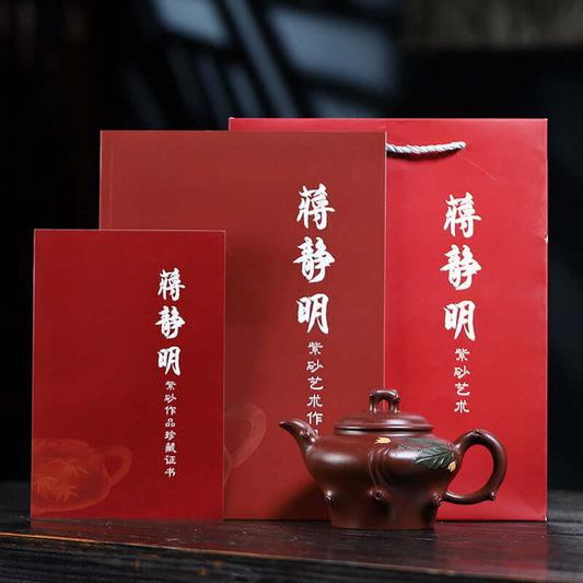 Handmade Yixing purple sand teapot with red packaging, featuring a decorative box and certificate for authenticity.