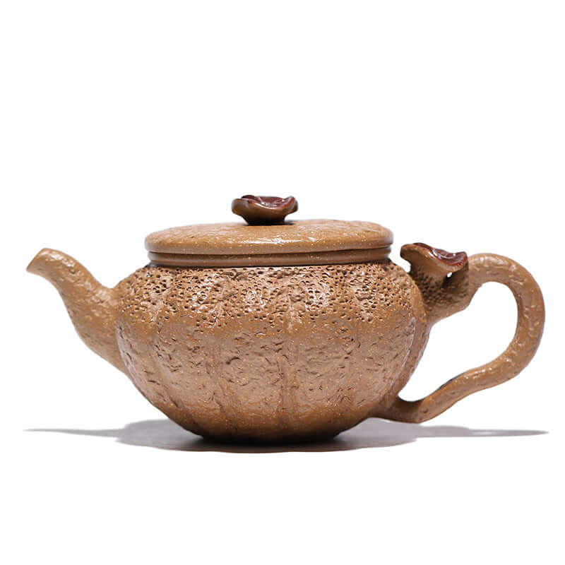 Handmade Yixing purple sand teapot with detailed texture and natural design, perfect for elegant tea serving.
