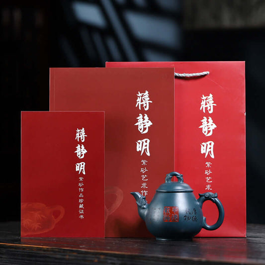 Handmade Yixing purple sand teapot with red packaging and certificate, showcasing traditional Chinese craftsmanship.