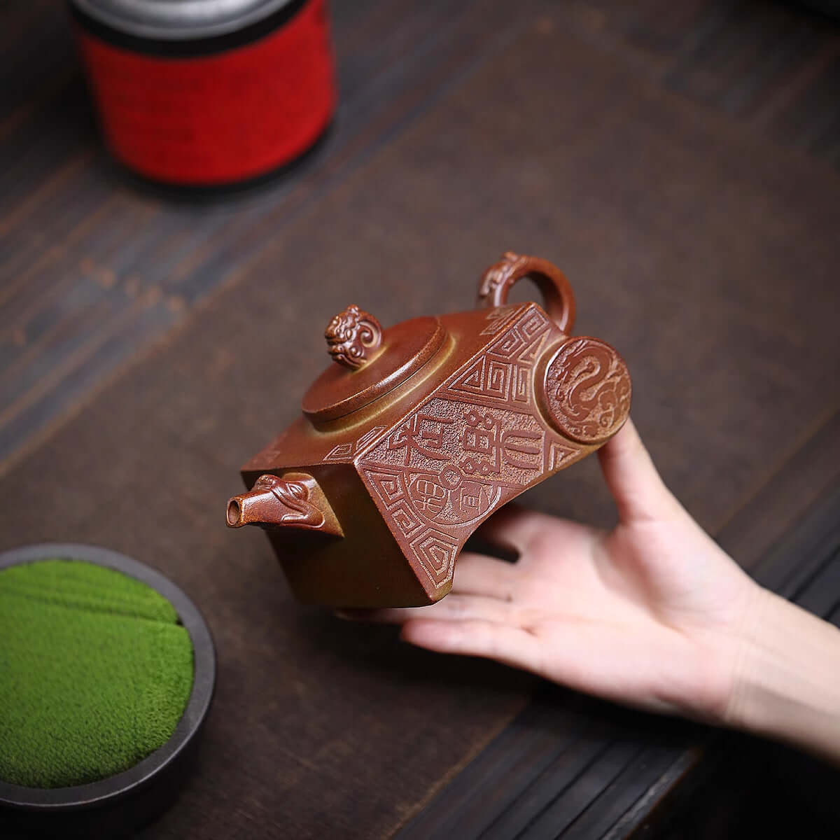 Handmade Yixing purple sand teapot with intricate designs, showcasing traditional craftsmanship and unique style.