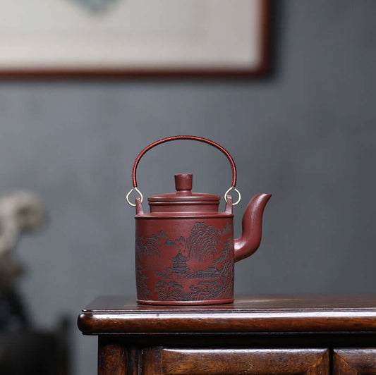 Handmade Yixing purple sand teapot with mountain scenery design, perfect for home kung fu tea set.