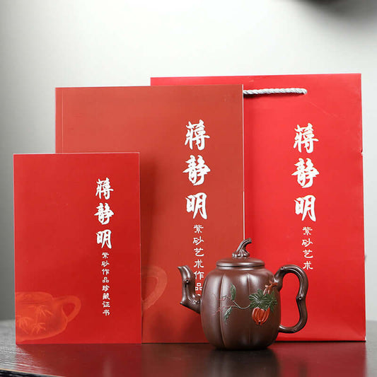 Handmade Yixing purple sand teapot in red gift box with artist certificate and booklet, showcasing traditional craftsmanship.