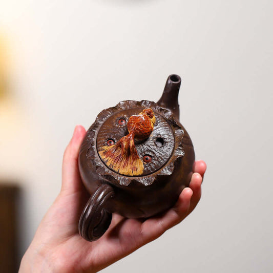 Handmade Yixing purple sand teapot with fish design, showcasing unique craftsmanship and beautiful detailing.