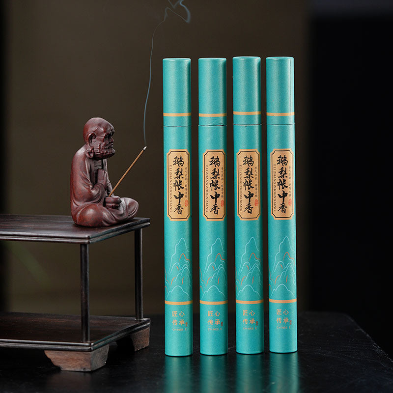 Handmade Yixing purple sand tea pet with incense holder, paired with traditional tea books, elegant tea accessories.